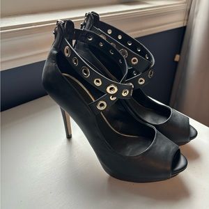 Black high heeled and gold trim shoes